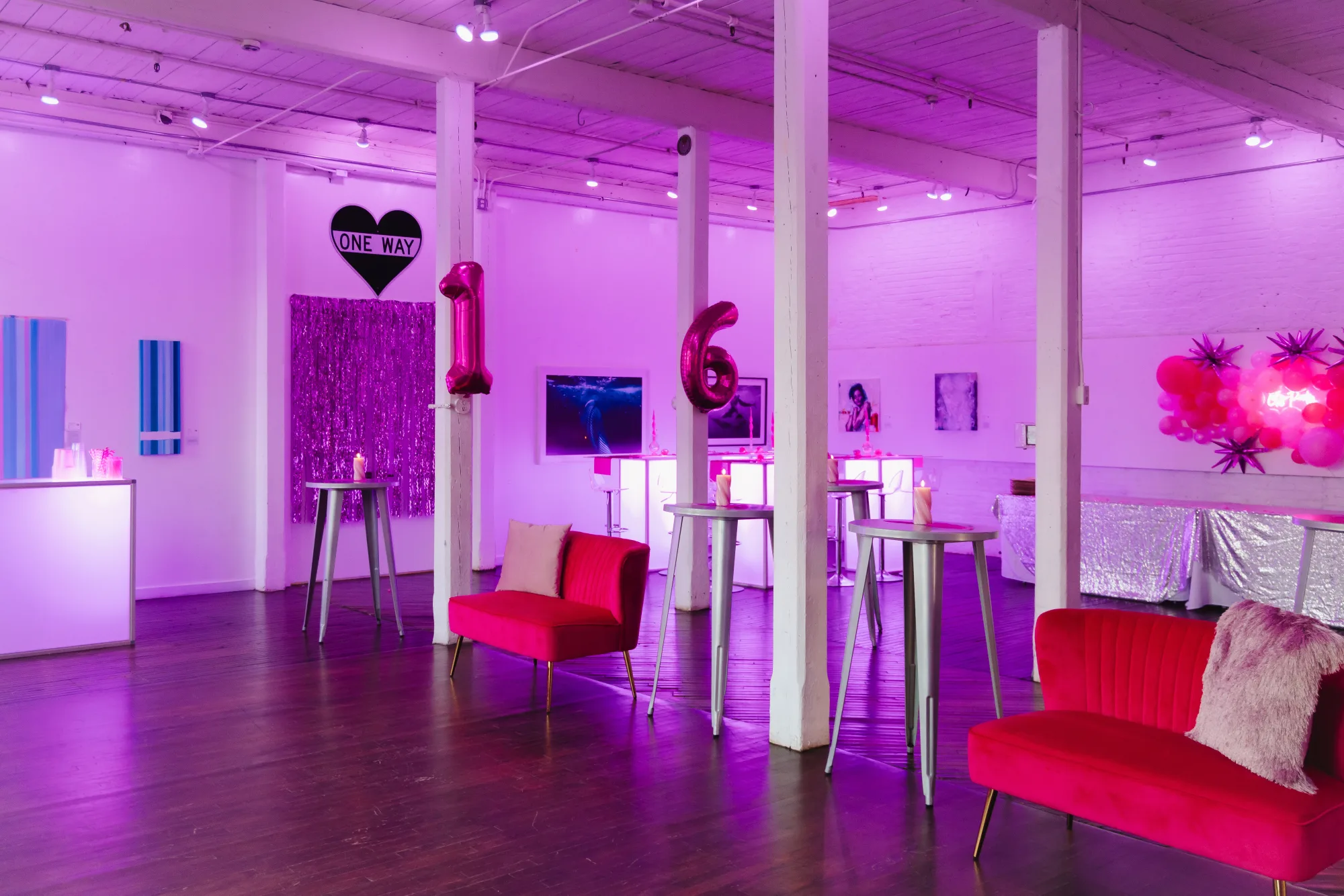 Sweet 16 celebration with pink number balloons, a black heart One Way sign, red velvet loveseats and a sequin backdrop in the Armstrong Gallery at The Knowlton in Bridgeport, CT.