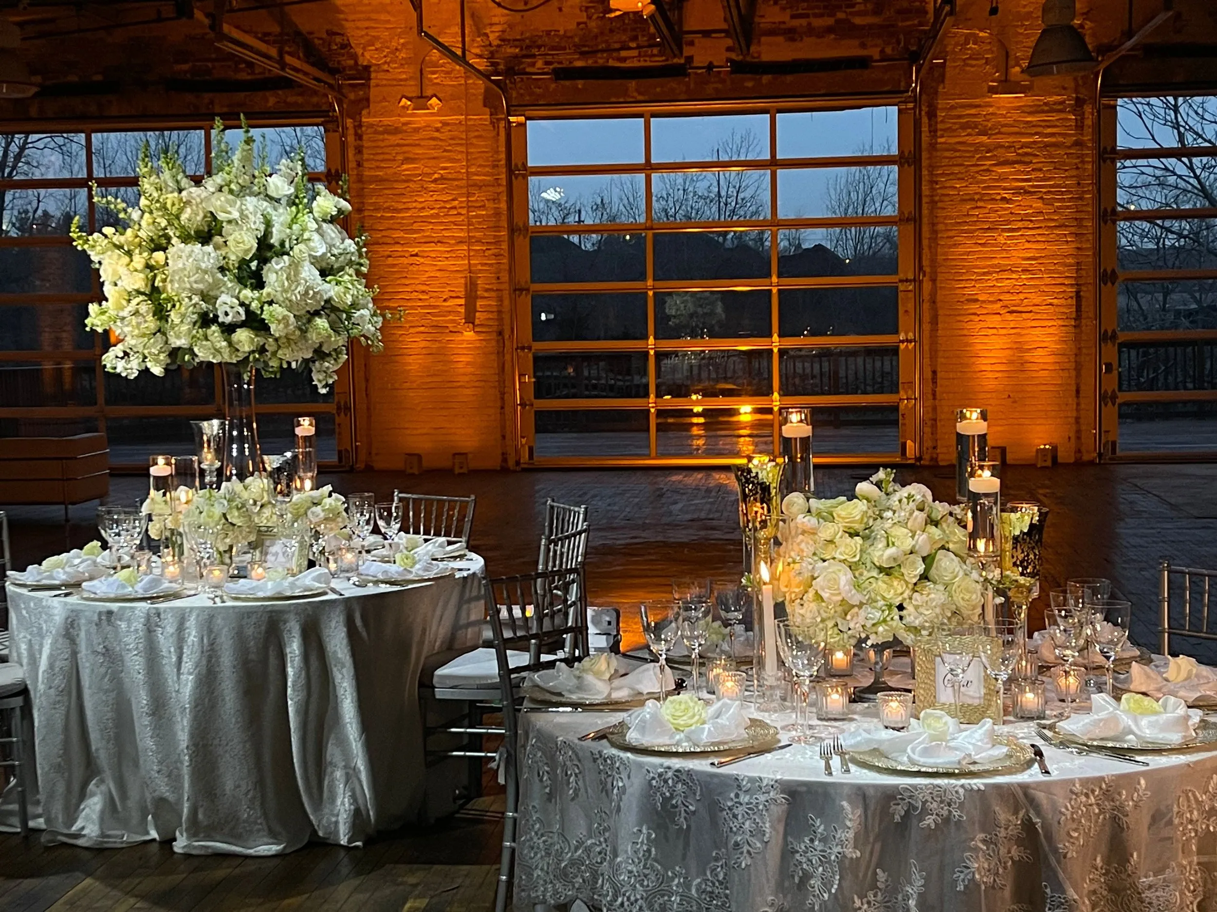 The Boathouse's three garage bay doors open to the dusk sky, the same rooms whether it is a single day booking or a larger production