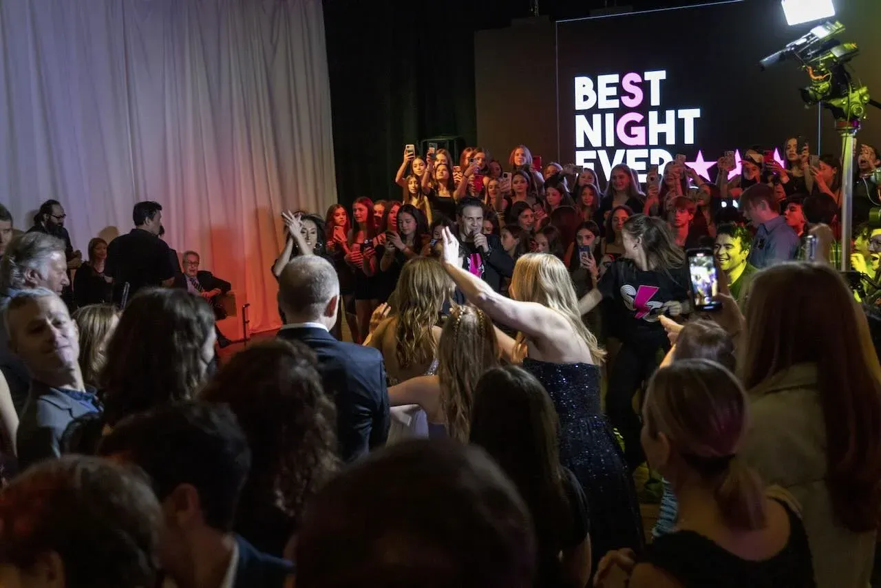 Guests dancing beneath a video wall at a mitzvah celebration