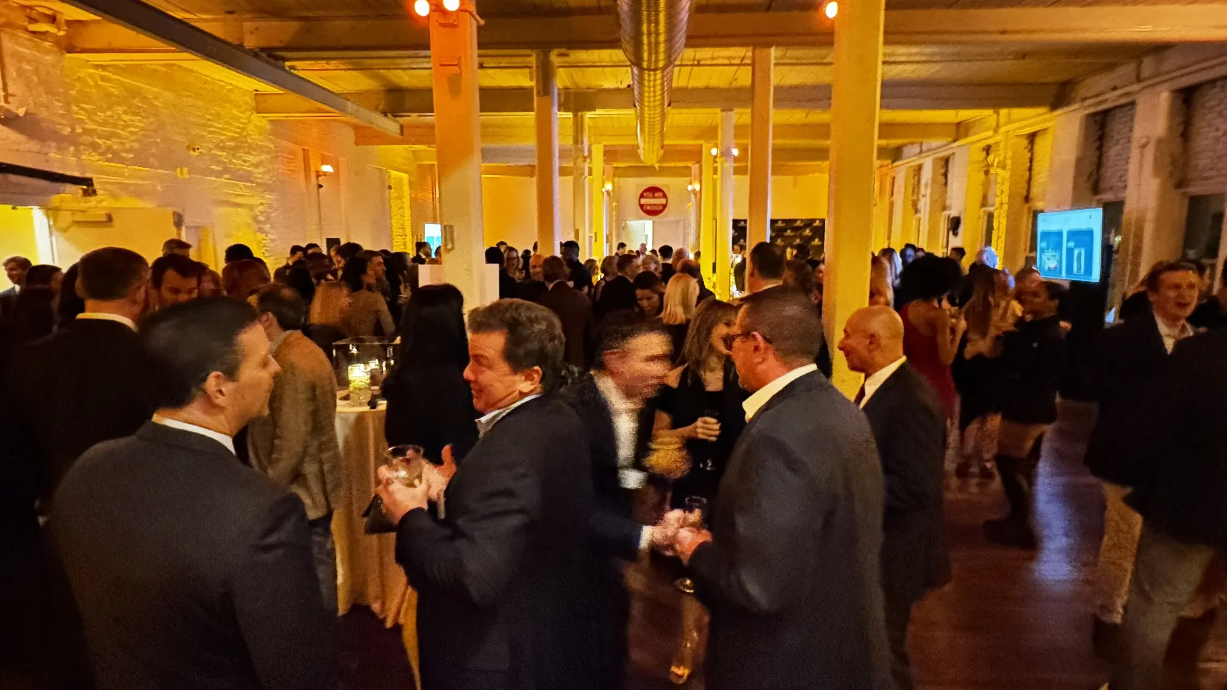 Guests talking in a lounge seating area under low ambient lighting at The Knowlton