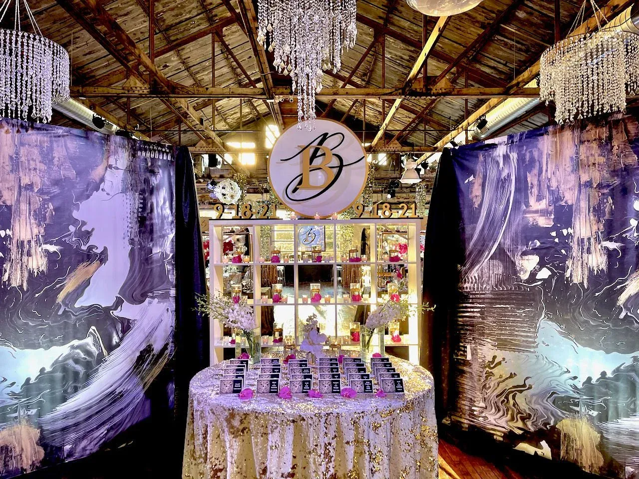 Purple and gold mitzvah lounge with crystal chandeliers under the timber-beam ceiling