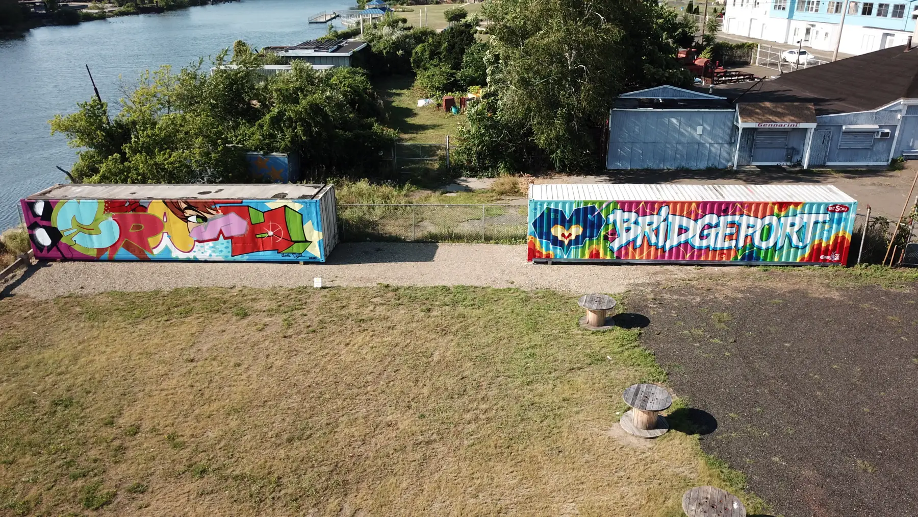 Aerial view of The Knowlton's mural park with the CrashOne and Tats Cru container murals beside the Pequonnock River in Bridgeport, CT