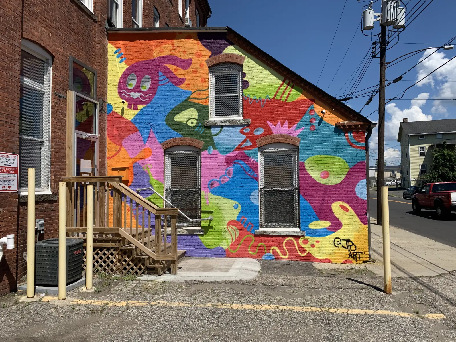John Paul O'Grodnick's first mural on this wall, colorful creatures covering the building corner, since repainted