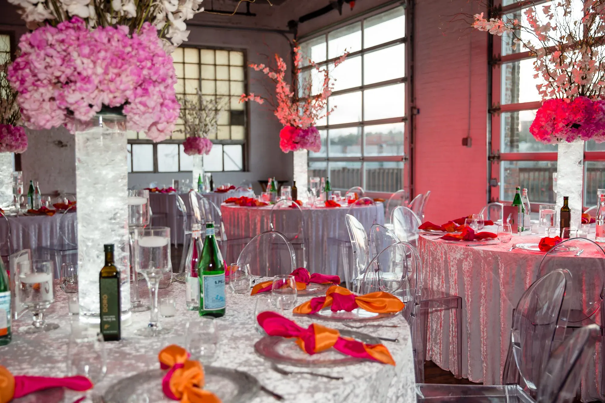 Pink and orange tablescape with cherry-blossom branch centerpieces